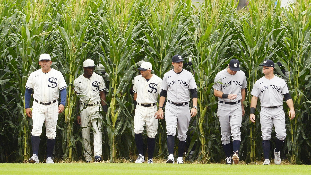 Kevin Costner leads the Yankees and White Sox out of the cornfield