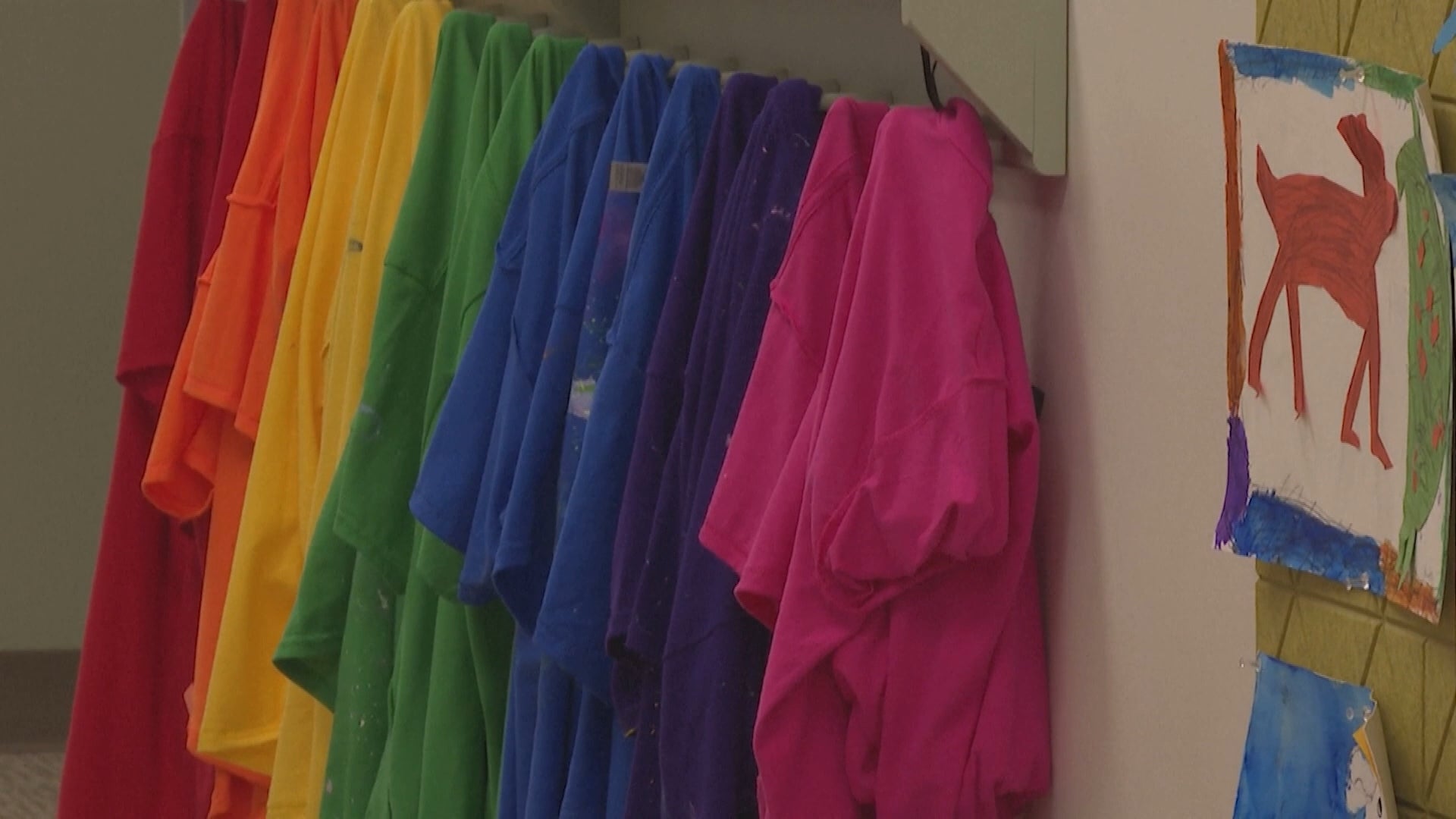 Shirts hanging in rainbow formation.