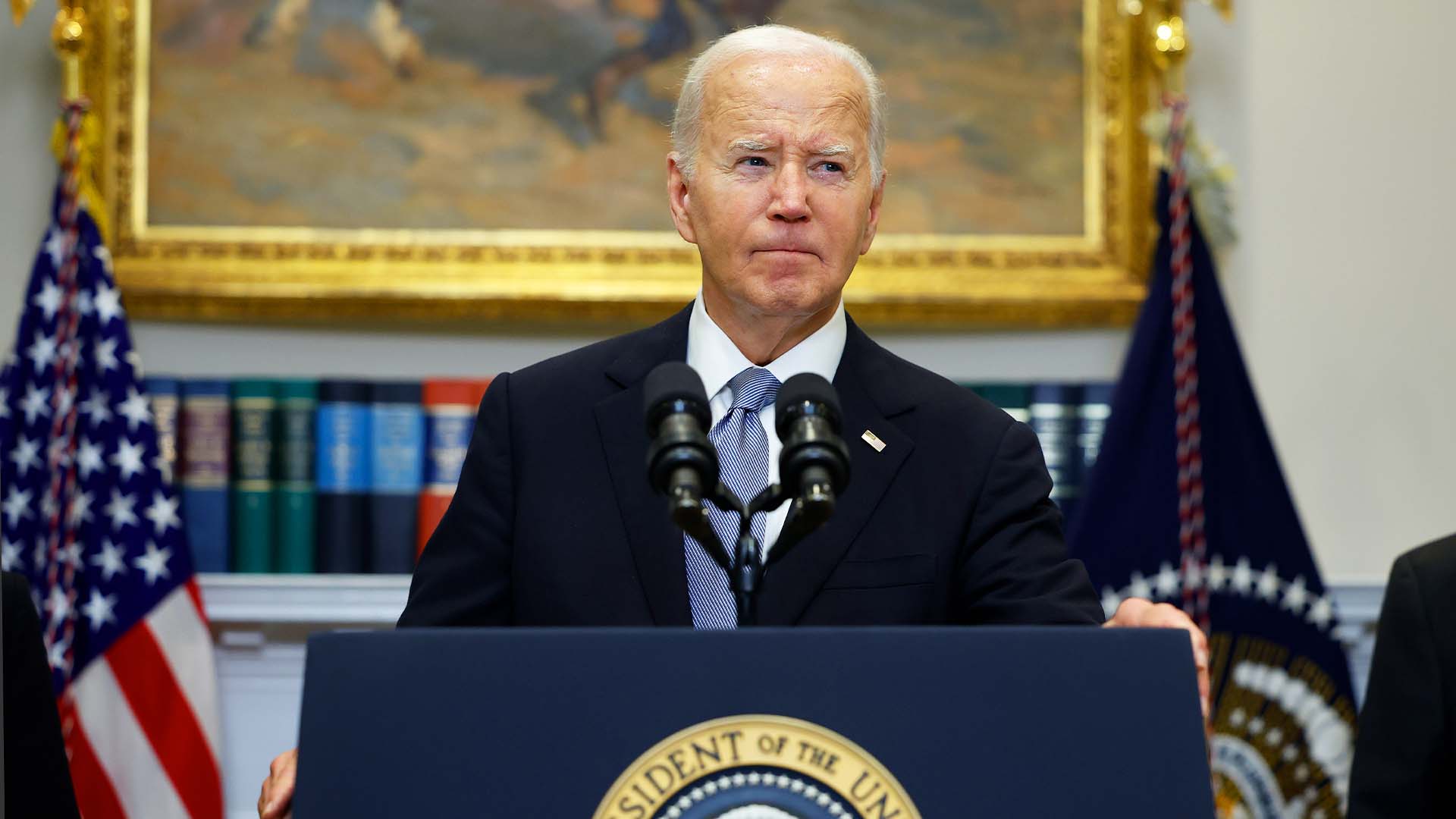 President Biden stands in front of podium