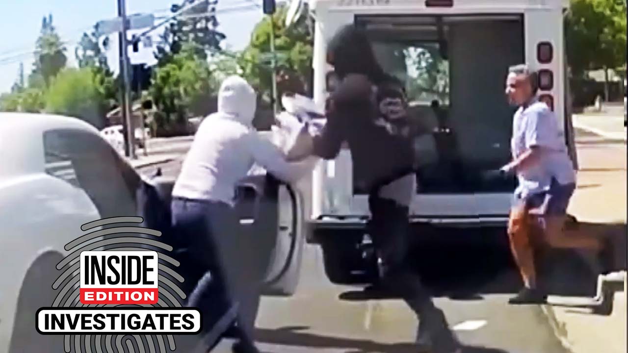 Thieves take a box of mail from the back of a mail truck.