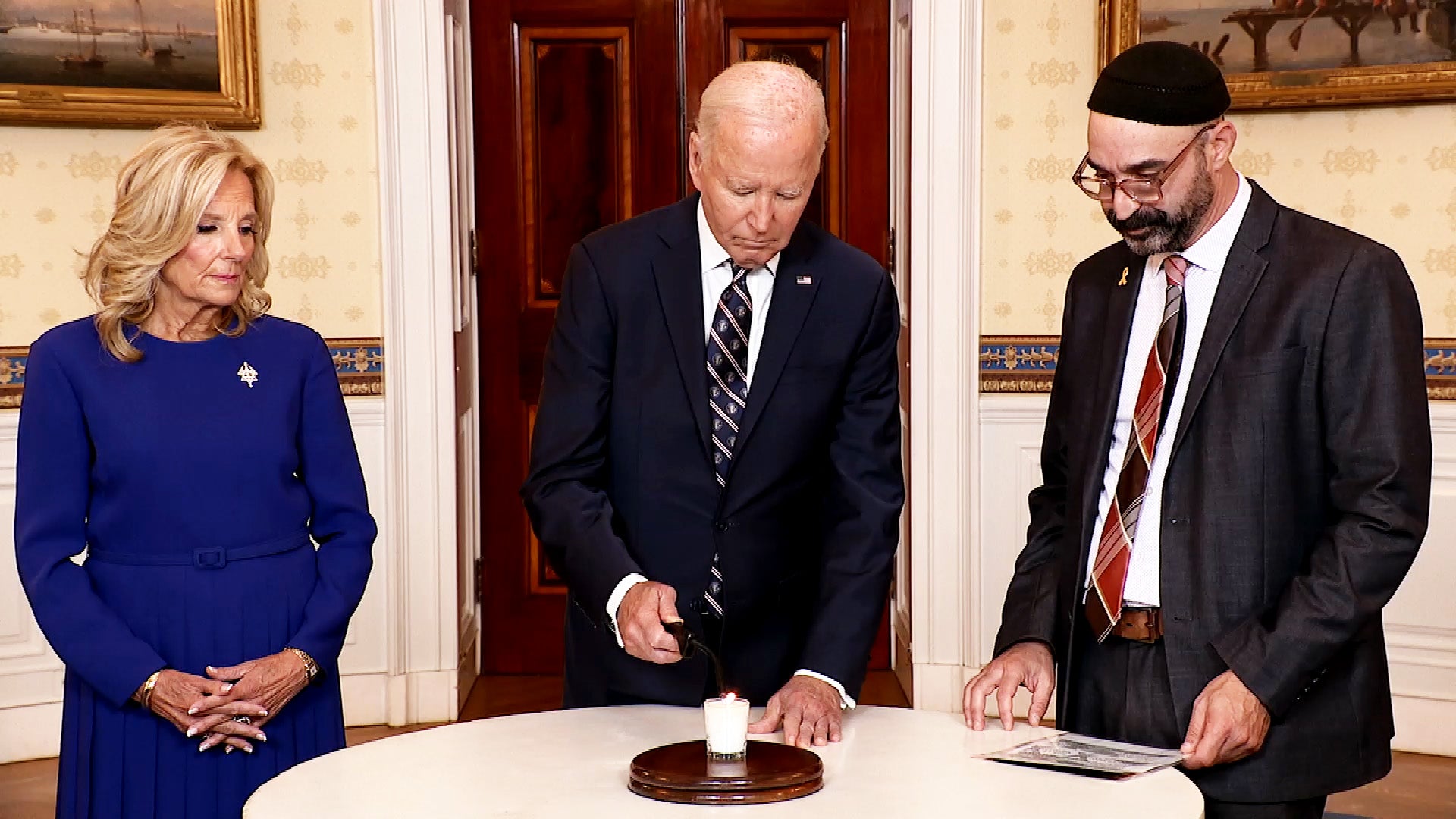 President Joe Biden lights a candle