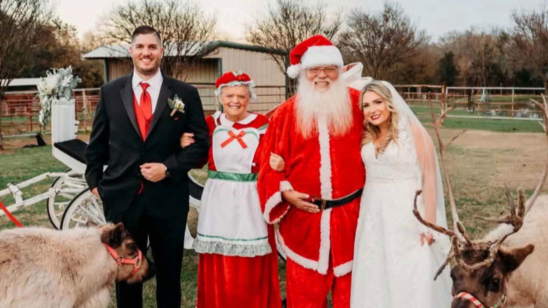 A bride and groom posing with Santa and Mrs. Claus on a farm