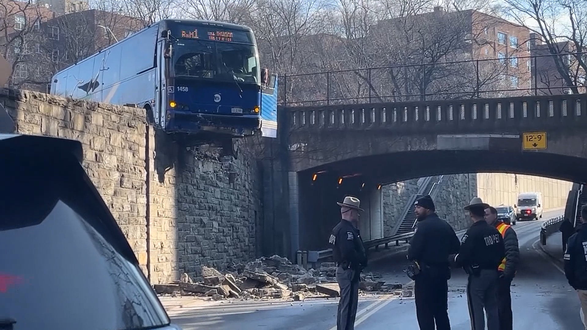 Bus dangles over railing