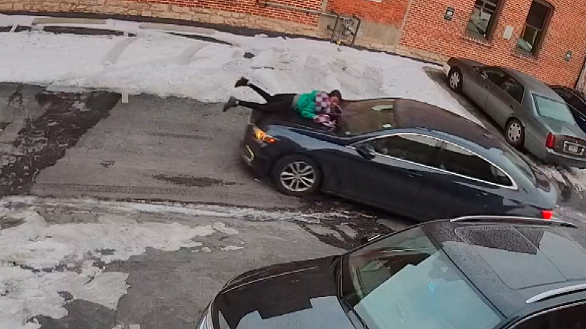 Carjacker Drives Away With Woman Clinging to Hood of Car