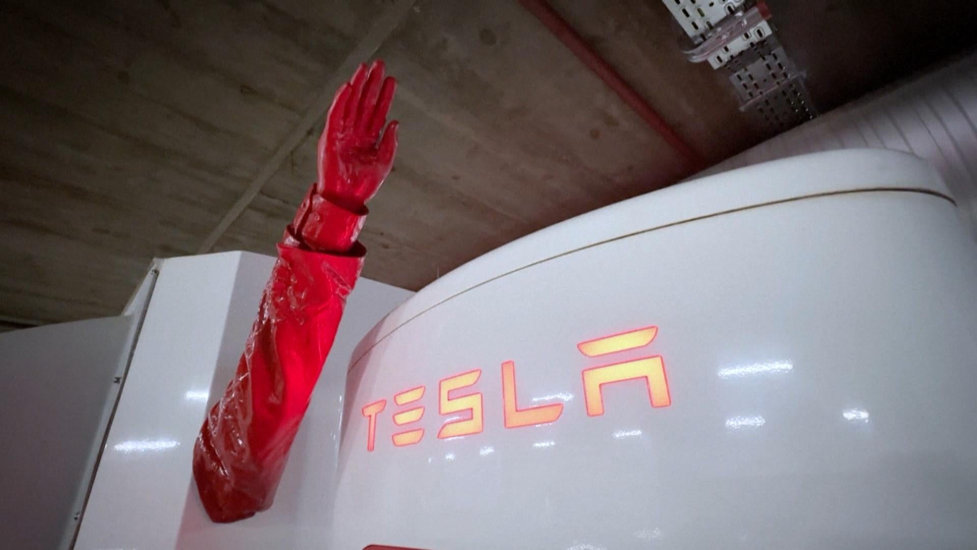 Artist Installs Raised Arm on Tesla Charging Station 