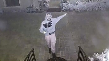 Unidentified person on surveillance camera pointing behind him