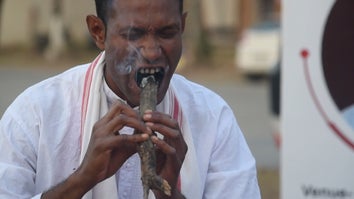 Man bites stick of burning charcoal