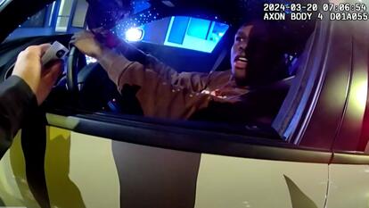 20-year-old Miles Hudson talking to police officer from inside his car