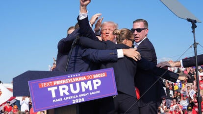 Former President Donald Trump raises his arm with blood on his face during a campaign rally at Butler Farm Show Inc. on Saturday, July 13, 2024 in Butler, Pennsylvania.