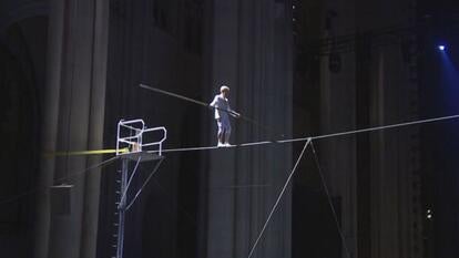 Philippe Petit walking on tightrope at cathedral