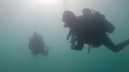 Kim and Nathan underwater in scuba gear