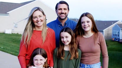 Derrick Anderson poses with friend's family