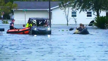 People on rescue boats and canoes after Hurricane Milton 