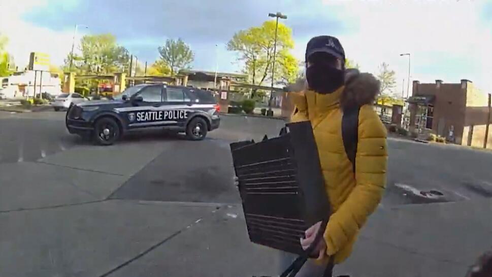 woman in face mask carries cash register