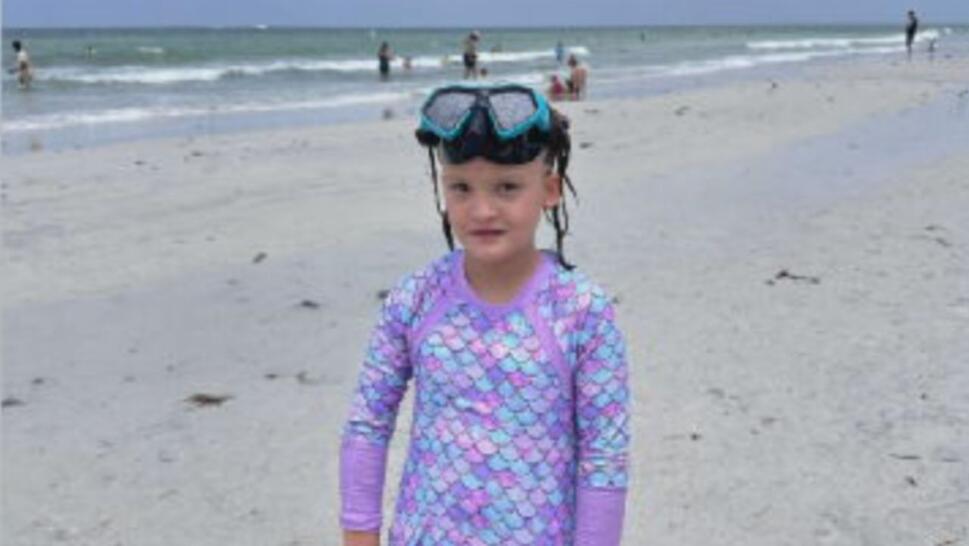 8-year-old Josie wearing purple swim suit