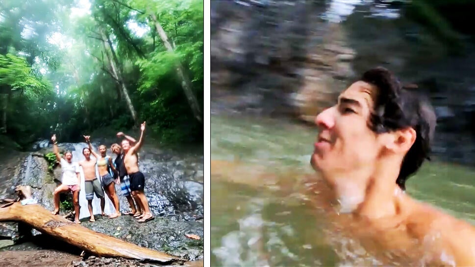 Teens pose in front of a waterfall