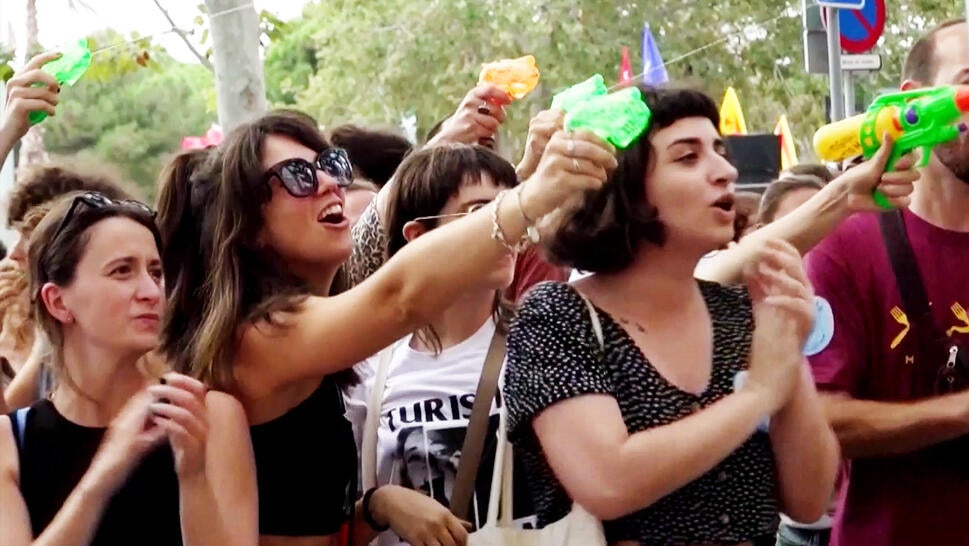 Protesters spray tourist with water guns