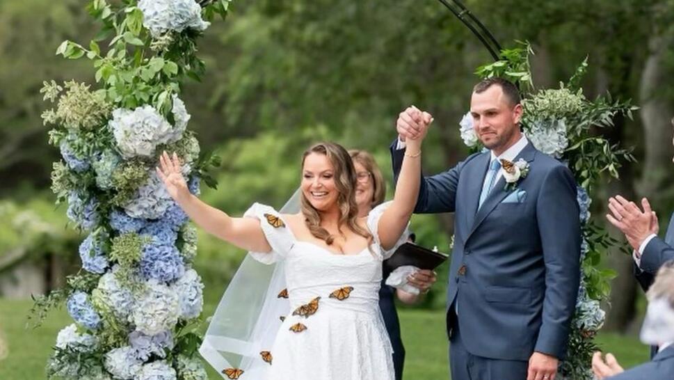 Monarch Butterflies Cling to Bride's Dress 