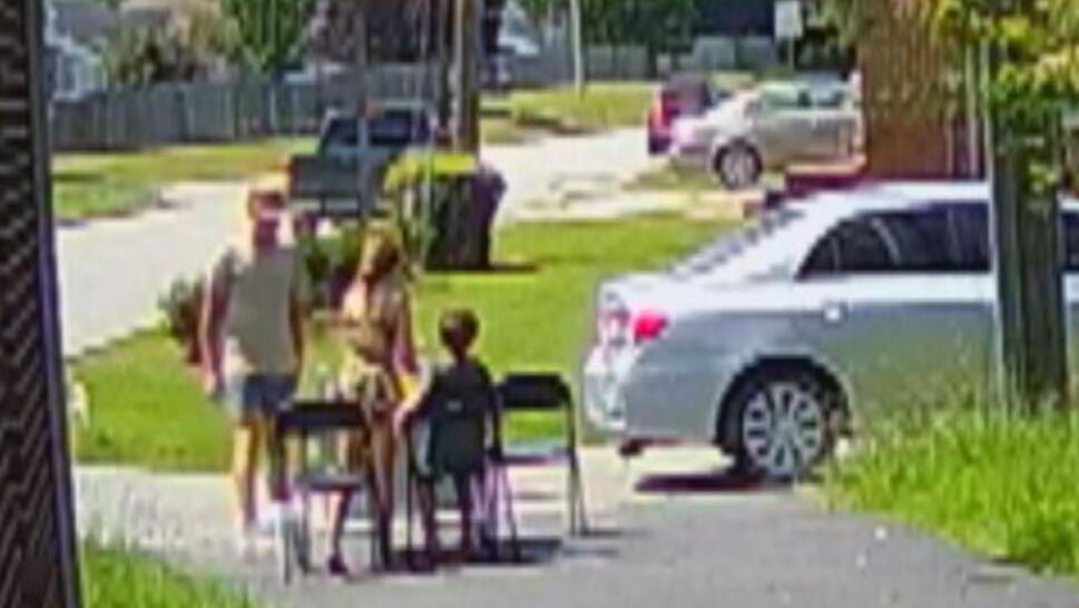 man standing at lemonade stand