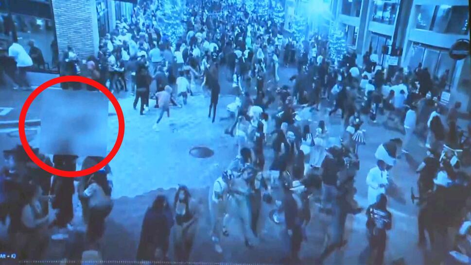 Surveillance of a crowded downtown with a red circle